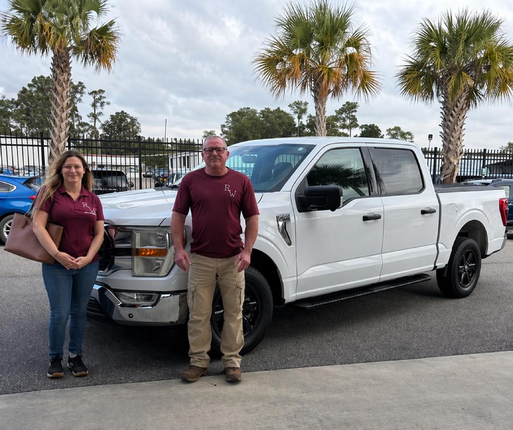 Rinkwell Plumbing team members standing next to service truck in Jacksonville Florida ready for plumbing service